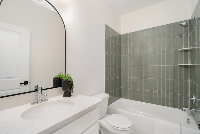 full bathroom featuring tiled shower / bath combo, vanity, and toilet