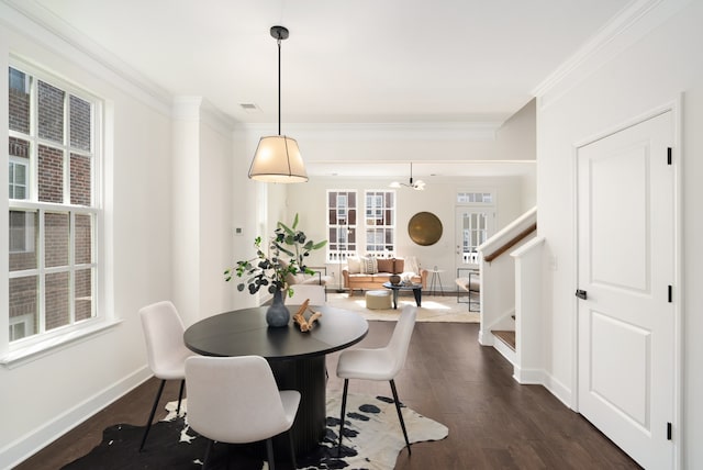 dining room featuring crown molding and dark hardwood / wood-style flooring