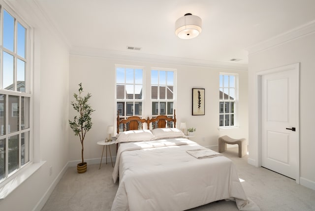 carpeted bedroom featuring multiple windows and crown molding