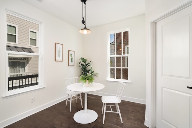 dining room with dark hardwood / wood-style flooring