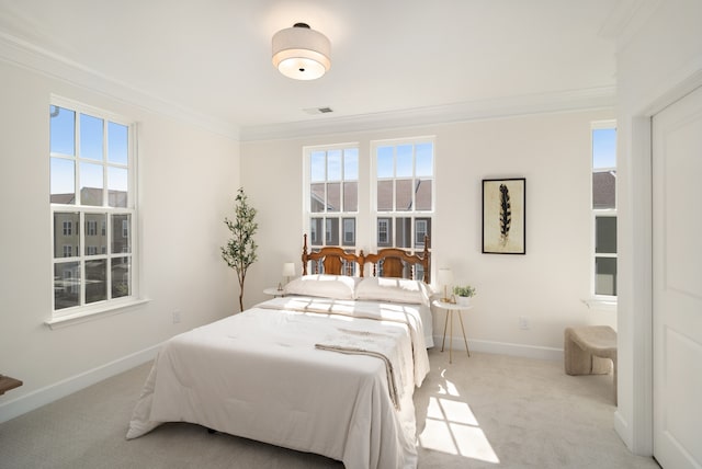 carpeted bedroom featuring ornamental molding and multiple windows