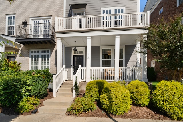 doorway to property featuring a balcony and a porch