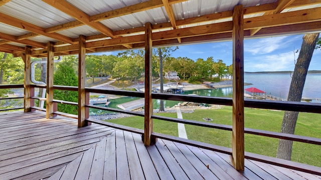 unfurnished sunroom with a water view and beamed ceiling