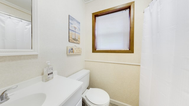 bathroom with walk in shower, vanity, and toilet