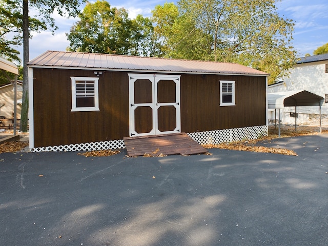 view of outbuilding featuring a carport