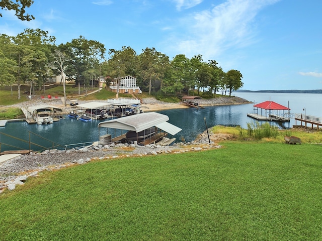 dock area with a lawn and a water view