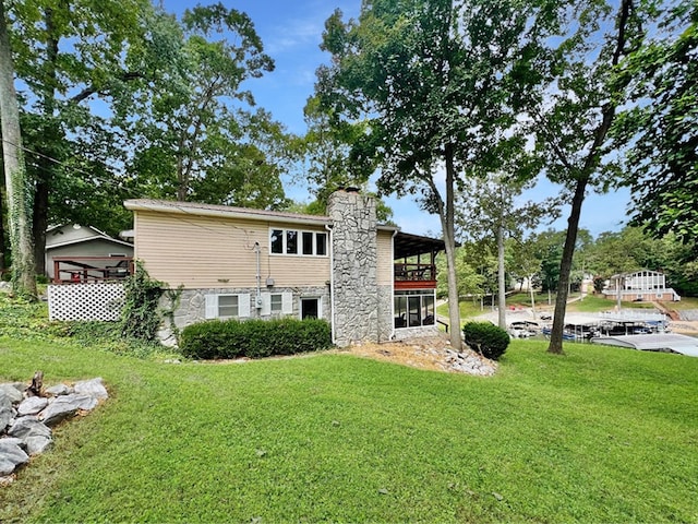 back of house with a lawn and a gazebo