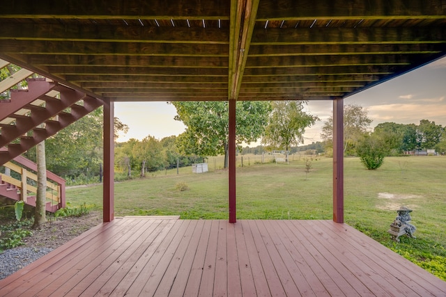 deck at dusk featuring a lawn and a pergola