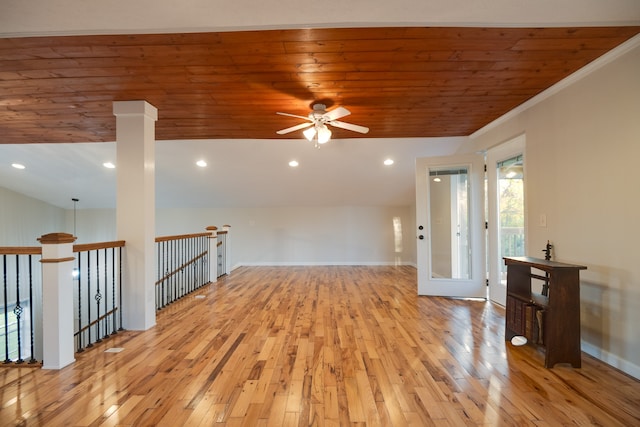 empty room with ceiling fan, light hardwood / wood-style flooring, crown molding, and wooden ceiling