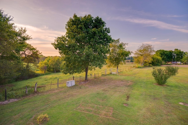 yard at dusk with a rural view