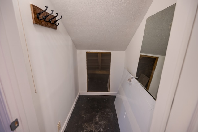 stairs with a textured ceiling