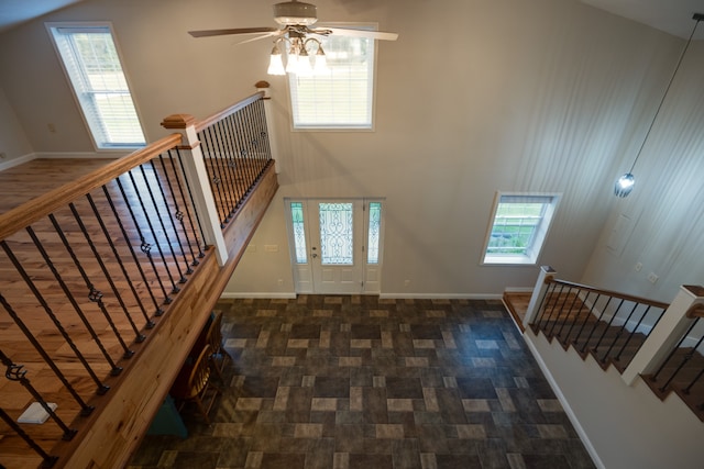 stairway with lofted ceiling and ceiling fan