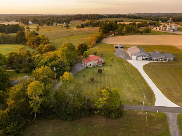 aerial view at dusk featuring a rural view