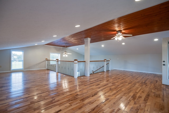 spare room featuring ceiling fan, lofted ceiling, and light hardwood / wood-style flooring