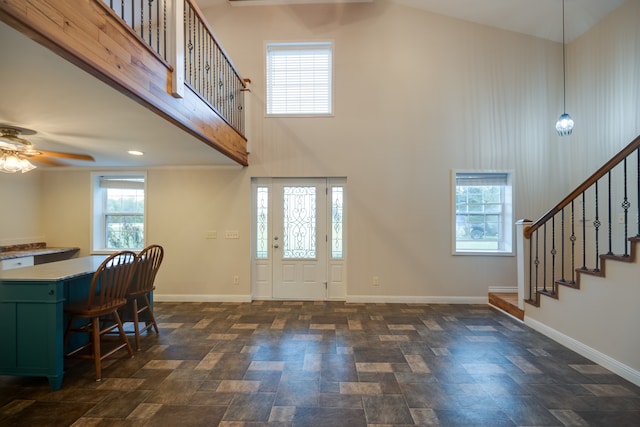 entrance foyer featuring ceiling fan, lofted ceiling, and plenty of natural light