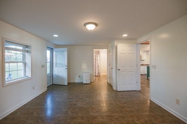 empty room featuring dark tile patterned flooring