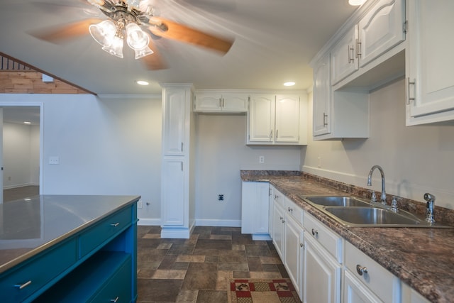 kitchen with crown molding, sink, ceiling fan, and white cabinets