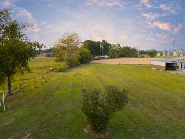 view of yard featuring a rural view and an outdoor structure