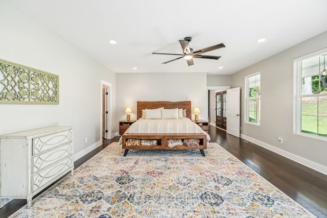 bedroom with dark hardwood / wood-style flooring and ceiling fan