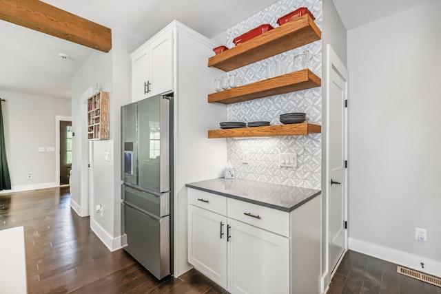 kitchen with white cabinetry, backsplash, dark hardwood / wood-style flooring, beamed ceiling, and stainless steel fridge with ice dispenser