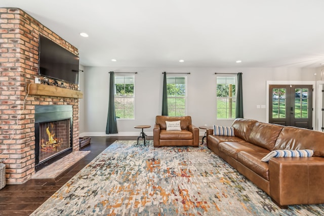 living room with french doors, a fireplace, and dark hardwood / wood-style floors