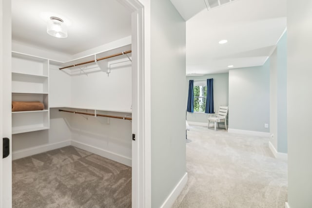 spacious closet featuring light carpet