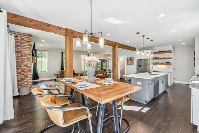 dining space with a chandelier, dark hardwood / wood-style floors, and sink