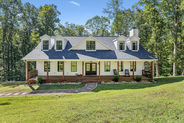 cape cod home with a porch and a front lawn