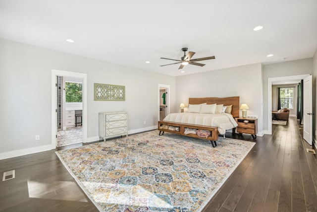 bedroom with ceiling fan, ensuite bath, dark hardwood / wood-style flooring, and multiple windows