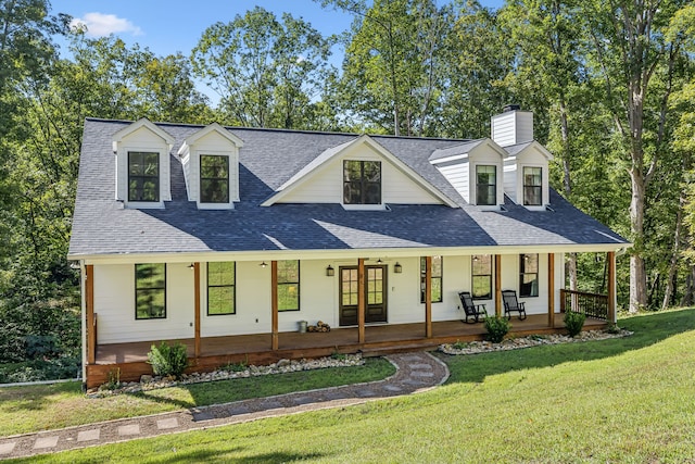 new england style home with a front yard and a porch