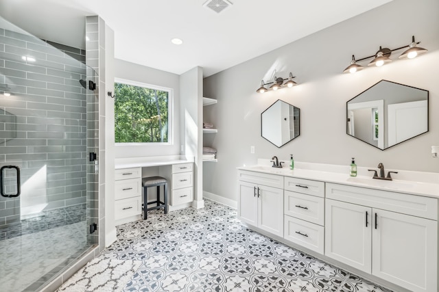 bathroom featuring a shower with door and vanity