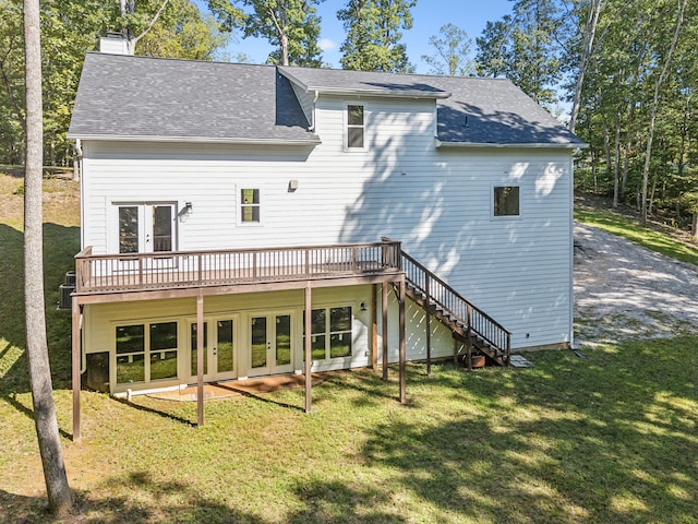 rear view of property with a lawn, a deck, and french doors