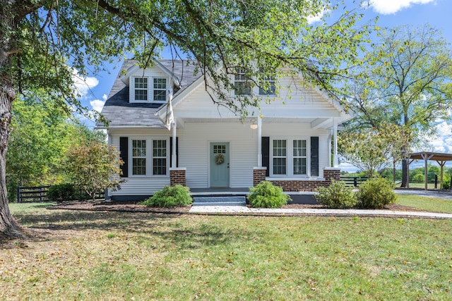 view of front of home featuring a front lawn and covered porch