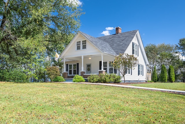 view of front facade featuring a front lawn and covered porch