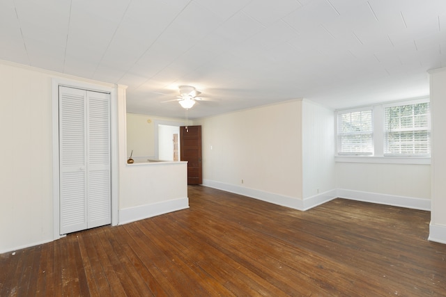 unfurnished room with ceiling fan, dark hardwood / wood-style floors, and crown molding