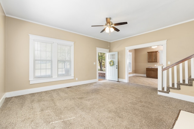 spare room featuring ornamental molding, ceiling fan, and light colored carpet