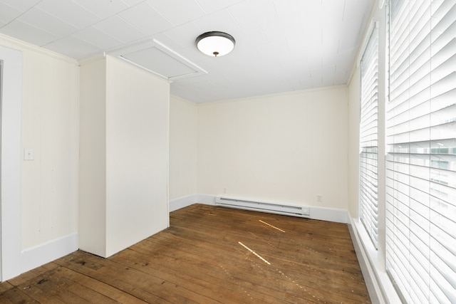 unfurnished room featuring crown molding, dark hardwood / wood-style flooring, and a baseboard radiator