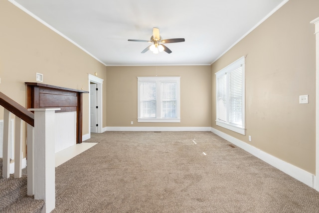 unfurnished living room featuring ceiling fan, light colored carpet, and ornamental molding