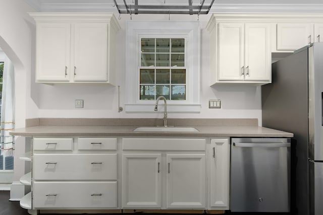 kitchen featuring white cabinetry, stainless steel appliances, sink, and a wealth of natural light