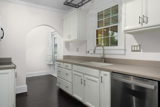 kitchen with dark wood-type flooring, sink, crown molding, stainless steel dishwasher, and white cabinetry