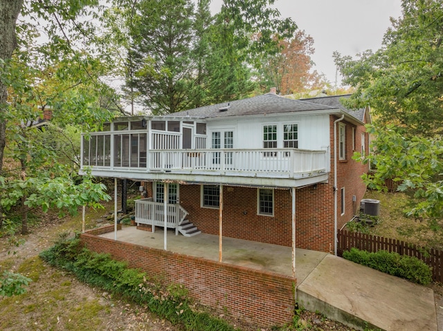 rear view of house featuring a sunroom, a patio area, and cooling unit