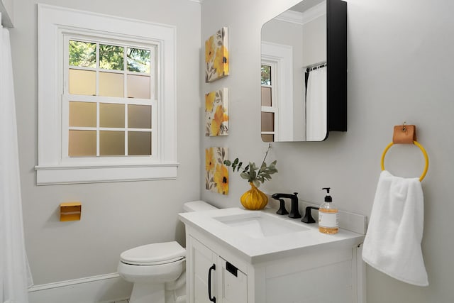 bathroom featuring vanity, toilet, and crown molding