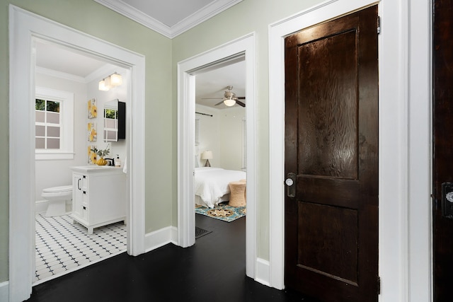 hall with ornamental molding and dark tile patterned floors