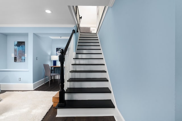 staircase with hardwood / wood-style floors and crown molding