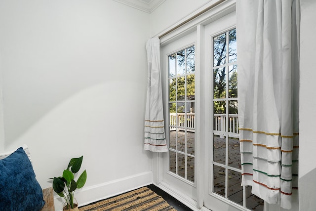 doorway featuring crown molding and wood-type flooring