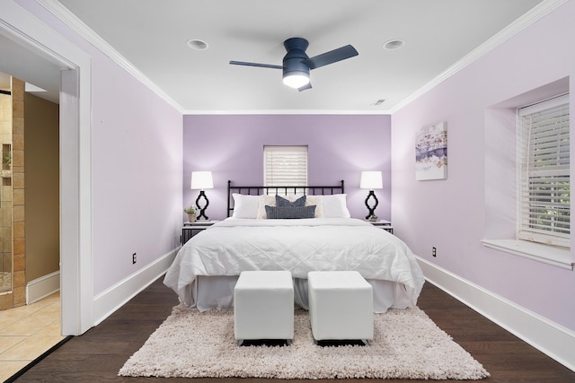 bedroom featuring ornamental molding, dark wood-type flooring, and ceiling fan