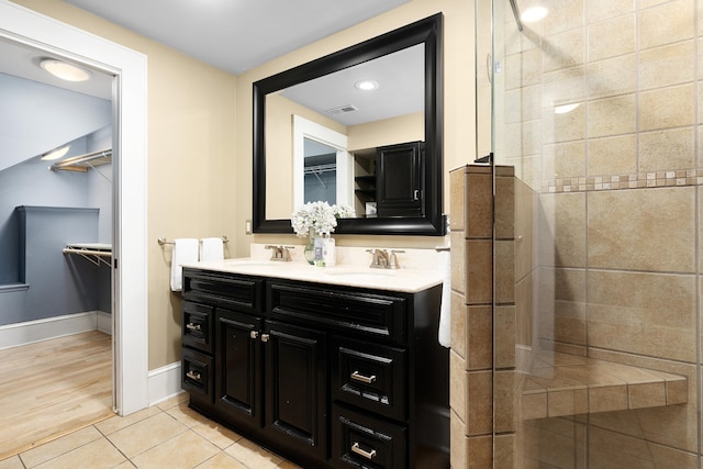 bathroom featuring vanity, hardwood / wood-style floors, and a tile shower