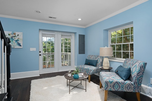 living area with electric panel, crown molding, a healthy amount of sunlight, and dark hardwood / wood-style flooring