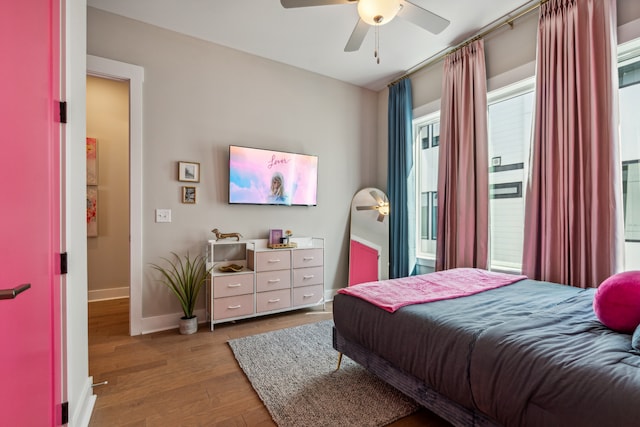 bedroom with light hardwood / wood-style floors and ceiling fan