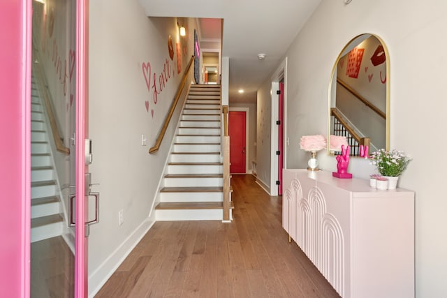 stairway with hardwood / wood-style floors